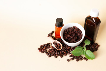 Natural cosmetic with coffee beans, sugar scrub in ceramic bowl, oil, shower gel, leaves of mint, seeds in wooden scoop. Home spa, anti cellulite care.