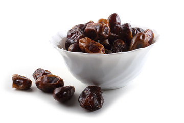 Date fruits on saucer isolated on white