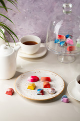 Tea in cup and chocolate candy, coffee in white cup