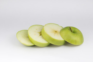 Top view closed up heap of green apple place on white floor. Sliced healthy green fruit.