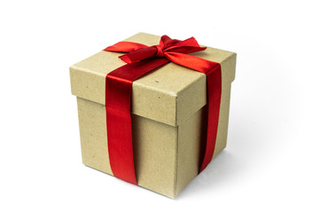 Gift box wrapped in recycled paper with red ribbon on a white background