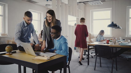 Fototapeta premium Attractive female leader encouraging multiethnic workers. Woman executive helping young colleagues in modern office 4K.
