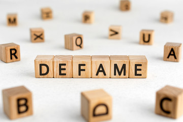 Defame - words from wooden blocks with letters, damage the good reputation defame concept, white...
