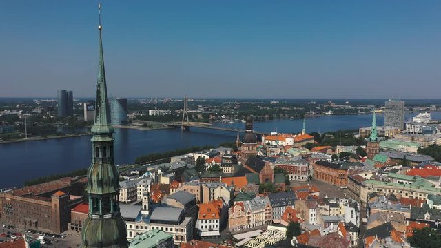 RIGA, LATVIA - MAY, 2019: Aerial drone view of the most famous spiers of the old city of Riga and the Daugava river.