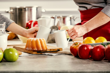 hands in the kitchen making dough on a wooden table. Free space for an advertising product