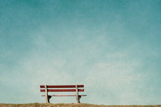 empty bench in an empty blue background