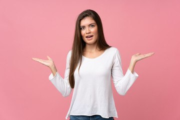 Young woman over isolated pink background with shocked facial expression