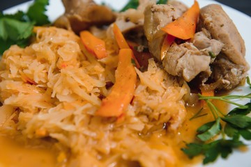 Fried cabbage in the white bowl on a rustic background
