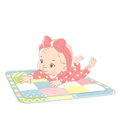 Cute little baby girl laying on stomach, on playing mat. 