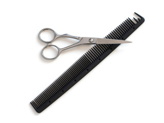 hairdresser professional scissors and black hairbrush comb isolated on white background close up
