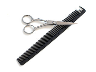 hairdresser professional scissors and black hairbrush comb isolated on white background close up