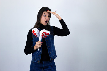 Fototapeta premium Simbolo de victoriapretty caucasian middle age woman with balloon i love you making victory or peace sign, isolated on gray background studio shotblack sweater, denim jacket, jeans, dark air. Place fo