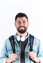Cheerful college student portrait, with headphones and school bag