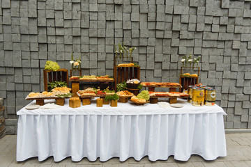 desserts with fruits, mousse, biscuits. Different types of sweet pastries, small colorful sweet cakes, macaron, and other desserts in the sweet buffet. candy bar for birthday