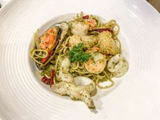 Spaghetti seafood recipe on white dish.