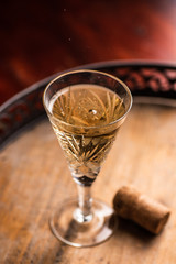 Prosecco wine in glass on rustick wooden tray. Dark Background