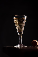 Prosecco wine in glass on rustick wooden tray. Dark Background