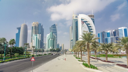 The high-rise district of Doha with traffic on intersection timelapse
