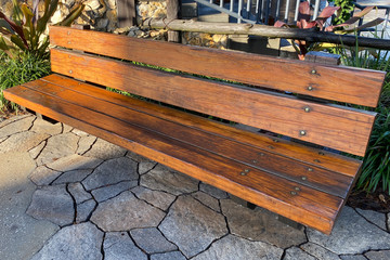 ornate wooden garden park bench stone path street