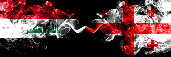 Iraq, Iraqi vs Georgia, Georgian smoky mystic flags placed side by side. Thick colored silky smokes flags together.