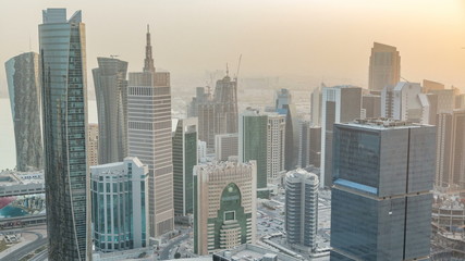 Fototapeta na wymiar Skyscrapers before sunset timelapse in the skyline of commercial center of Doha, the capital Qatar