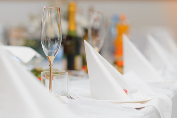 Glasses on the festive table setting. Wedding table decor concept. Table setting in classic style, setout. fine art.