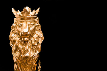 gold lion with crown  statue on black  background , king of the animal