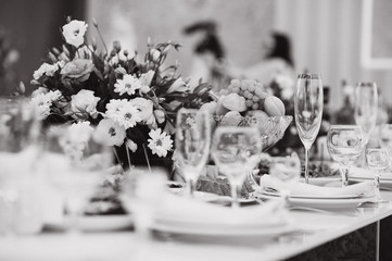 Glasses on the festive table setting. Wedding table decor concept. Table setting in classic style, setout. fine art.