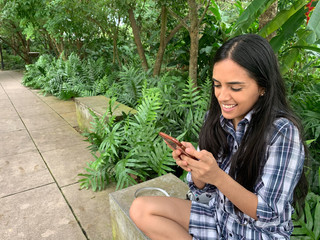 Young latin girl using smartphone, Panama city, Panama, central America
