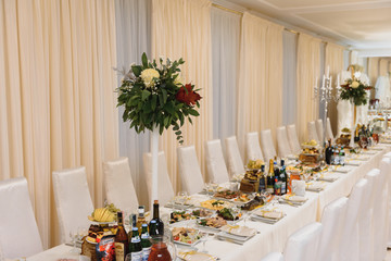 Glasses on the festive table setting. Wedding table decor concept. Table setting in classic style, setout. fine art.