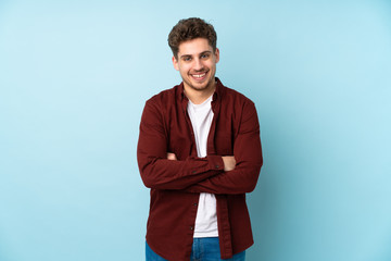 Young caucasian man isolated background keeping the arms crossed in frontal position