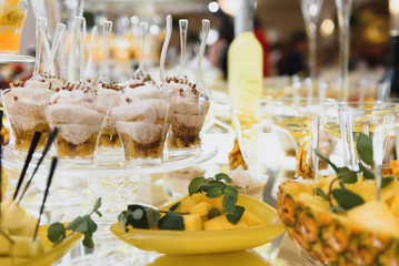 Delicious sweets on wedding candy buffet with desserts, cupcakes,tiramisu and cookies