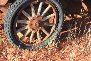 Fototapeta na wymiar Wooden spoke wheel of rusting Model T Ford in the South Ausralian Outback