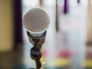 Close up of microphone on abstract blurred background for speech in seminar room or communication and speaking conference hall, Background concept.