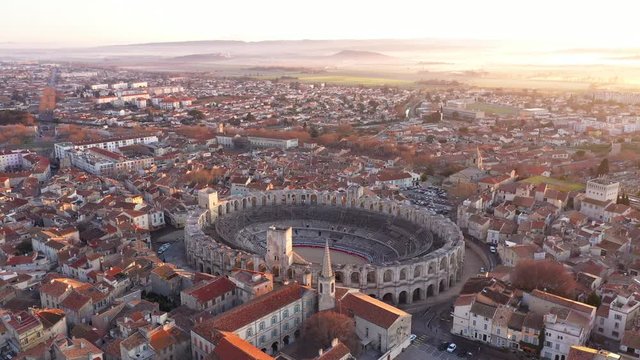 Amazing epic sunrise over Arles arena amphitheatre France foggy fields in background