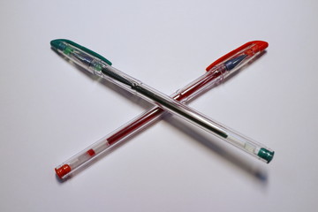 red and green pen on a white background