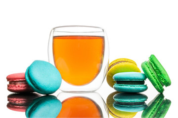 Glass cup black tea, macaroons cookies Isolated on white. Colorful and sweet French macaroons background