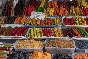 A counter with with dried fruits and local sweetness-churchkhela at the authentic bazaar of a resort town on the Black Sea coast of the Caucasus.