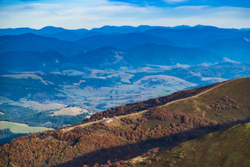 Mountain landscape. change of seasons of autumn. In the background there are bright autumn trees.