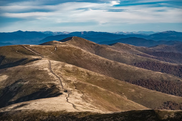 Mountain landscape. change of seasons of autumn. In the background there are bright autumn trees.