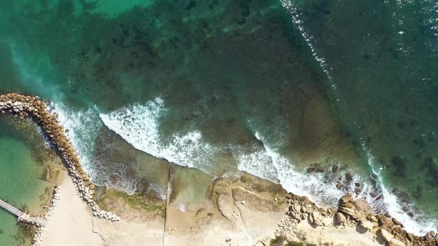 Top aerial view of waves crushing on Martigues mediterranean coast line blue water sunny day France 