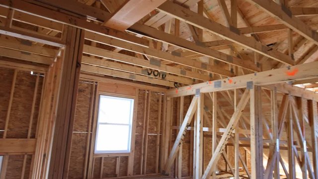 Beam built home under construction wooden truss, post and beam framework frame house