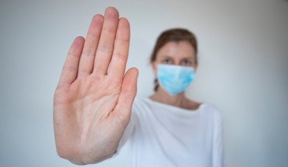 stop coronavirus woman wearing medical mask and raising hand 2019-nCoV fight - spreading