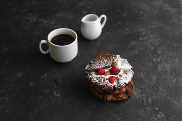 Homemade chocolate waffles with powdered sugar on a plate of raspberries with ice cream and chocolate on a dark background space for text
