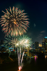 Fototapeta premium Beautiful firework display for celebration happy new year and merry christmas with Twilight night and firework lighting in bangkok cityscape background, Bangkok, Thailand.