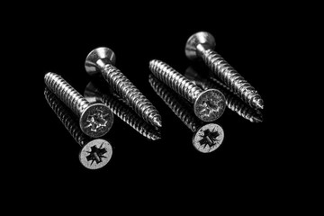 macro screws on a black background