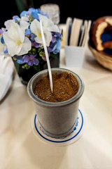 ceramic pot with sweet mustard accompaniment to Bavarian white sausages
