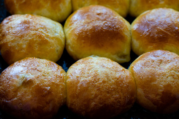 Baked hot buns. Sweet buns on a baking sheet