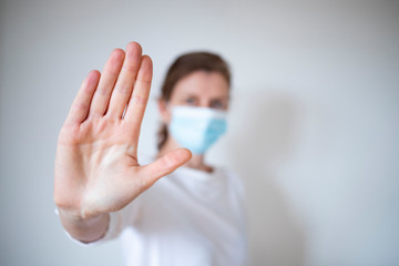 stop coronavirus woman wearing medical mask and raising hand 2019-nCoV fight - spreading