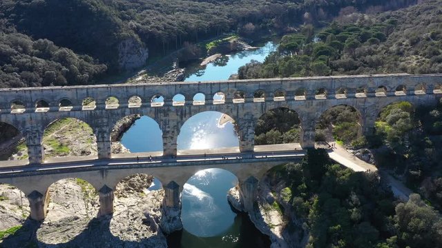 Bridge Pont du Gard aerial shot sunny reflection on the Gardon river France 